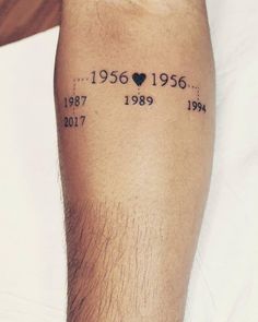 a man with a tattoo on his leg that has the date and year in it