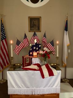 an altar with american flags and candles on it