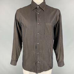 SAN FRANCISCO'S FAVORITE DESIGNER CONSIGNMENT STORES AND ONLINE SHOP ERMENEGILDO ZEGNA Size L Brown Stripe Cotton Button Down Long Sleeve Shirt IN-STORE ID: 112232 ERMENEGILDO ZEGNA Long sleeve shirt comes in brown striped cotton featuring a patch pocket at left front panel, hidden button down collar, one button round cuff, and button up closure. Made in Italy. Very Good Pre-Owned Condition. Marked: L Measurements: Shoulder: 20 in. Chest: 50 in. Sleeve: 26.5 in. Length: 32 in.   Original Retail Striped Business Tops With Buttons, Striped Button-up Top For Semi-formal Occasions, Vintage Long Sleeve Business Shirt, Semi-formal Brown Button-up Top, Brown Semi-formal Button-up Top, Brown Button-up Top For Semi-formal Occasions, Ermenegildo Zegna, Button Down Collar, Button Downs