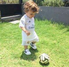 a small child is playing with a soccer ball