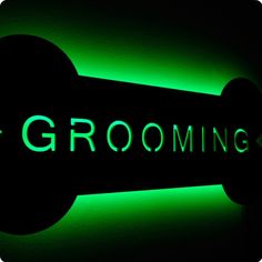 a black and green sign that says grooming