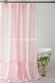 a pink shower curtain with ruffled edges