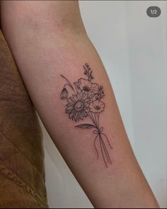 a woman's arm with flowers on it