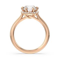 a rose gold engagement ring with an oval center stone surrounded by small round diamonds on the sides