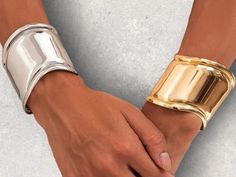 ✨ Elevate your style with our chic Gold & Silver Metal Wide Cuff Bangles! 🌟 These versatile punk-inspired bracelets are perfect. Made with high-quality metal, they offer a sleek, modern look that stands out. 💫 Whether you're dressing up for a special occasion or adding flair to your everyday ensemble, these bangles are the perfect choice. 🎁 They also make a fantastic gift for the fashion-forward women in your life! 👸 🌟 Features: Stylish gold and silver color options Wide cuff design Ideal f Trendy Cuff Bangle For Parties, Trendy Metal Cuff Bracelet, Trendy Metal Bangle For Parties, Trendy Party Bangle Cuff Bracelet, Trendy Silver Cuff Bracelet, Inspired Bracelets, Cuff Design, Punk Inspiration, Simple Bracelets