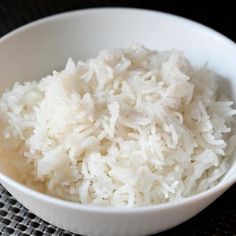 a white bowl filled with rice on top of a table