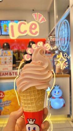 a hand holding up an ice cream cone in front of a store window with the word ice cream on it