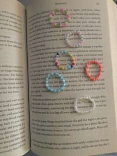 an open book with beaded bracelets on it