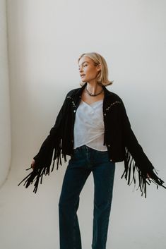 Black is a staple color and the fringe detail is all we've ever wanted and more! Suede Eyelet detail Fringe jacket 90% polyester 10% spandex Model is 5'1" and wearing a size small. The length of a size small measures 20.5". Small: 2-4 Medium: 6-8 Large: 10-12 Short Fringe Jacket, Spring Black Tasseled Outerwear, Fitted Fringe Outerwear For Winter, Fitted Fall Outerwear With Tassels, Black Fringe Outerwear For Fall, Fitted Outerwear With Beaded Fringe For Fall, Fitted Beaded Fringe Outerwear For Fall, Trendy Beaded Fringe Fall Outerwear, Winter Outerwear With Beaded Fringe And Long Sleeves