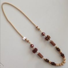 Necklace With Brown Bronze Pearlized Beads With Amber Colored Crystals And Gold Metallic Accents On A Gold Link Chain 41 Inches In Length Elegant Brown Spacer Beads, Elegant Brown Beaded Necklace With Spacer Beads, Elegant Brown Beads For Parties, Gold Link Chain, Gold Link, Amber Color, Metallic Accents, Color Crystal, Brown Gold