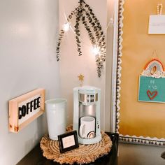 a coffee maker sitting on top of a table next to a cup holder and mug