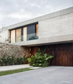 a modern house with large wooden garage doors