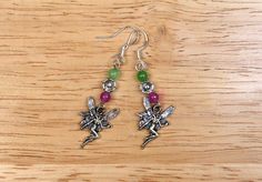 I created these Beltane Earrings to celebrate May Day. These Earrings feature a Fairy charm and flower bead with dyed agate beads in green and magenta.  If you would like to see the process for making the jewelry, you can watch my Handmade Beltane Jewelry video  on the Magical Crafting YouTube channel. https://www.youtube.com/channel/UCyITmMOxt6IvhubQmsgBZQQ Handmade Fairy Style Dangle Jewelry, Handmade Fairy Dangle Jewelry, Fairy Style Jewelry With Matching Earrings Gift, Green Fairy Earrings For Gift, Fairy Style Drop Earrings For Gifts, Fairy Style Green Earrings For Gifts, Handmade Fairy Drop Earrings, Handmade Fairy Style Drop Earrings, Fairy Style Handmade Dangle Earrings