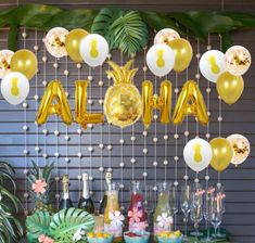 an aloha party with balloons and pineapples