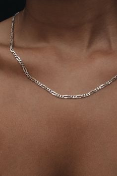 Maximum length: 20 ½ ” | 52 cm Minimum length: 18 ½” | 47 cm Extension length : 2” | 3 cm Chic modern chain necklace - solid sterling silver figaro chain, extension, and a logo tag. Suitable both for daily wear and special occasions. Wear it solo or mix and match it with other jewelry pieces from the Links collection to create a complete fashion statement. The necklace is 20 ½ ” total length with a 2” extension to wear it shorter. We are happy to make a custom-length piece if a different size wi Classic Sterling Silver Figaro Chain Necklace, Modern Silver Necklace With Figaro Chain, Trendy Silver Jewelry With Figaro Chain, Trendy Silver Figaro Chain Necklace, Sterling Silver Figaro Chain Necklace For Everyday, Modern Sterling Silver Necklace With Figaro Chain, Everyday Sterling Silver Figaro Chain Necklace, Modern Sterling Silver Figaro Chain Necklace, Silver Figaro Chain