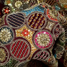 an elephant covered in lots of different colored beads and sequins on it's back