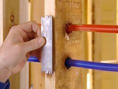 a person is working on an electrical wire box with blue and red wires attached to it