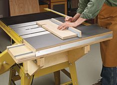 a man working on a table sawing wood with a mitt and vise