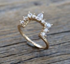 a diamond ring sitting on top of a wooden table