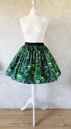 Circuti Board Skirt Gathered  full skirt made from a beautiful 100% cotton,  Circuit Board fabric. Each skirt is made by gathering the fabric onto  a 2 inch black elastic waistband. The length measures from the top of the waistband and comes in three lengths, 19", 22" or 25". Please choose length from the drop down menu. The waist measurement can be seen in the measurement guide below. Please choose waist size from the drop down menu. The skirt is pictured with a petticoat to show its potential Tiered Cotton Mini Skirt For Party, Party Cotton Tiered Mini Skirt, Cotton Long Skirt For Party, Green Cotton Midi Skirt, Green Pleated Party Skort, Green Stretch Cotton Skort, Retro Cotton Mini Skirt, Flared Cotton Skirt For Party, Green Stretch Mini Skirt With Lined Skirt