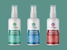 three bottles of botanical deodorant on a green background