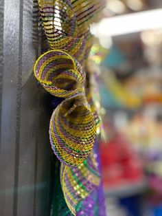 a close up of a colorful ribbon hanging on a door