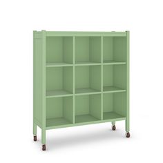 a green bookcase with four shelves and wheels on the bottom, in front of a white background