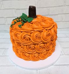 an orange cake decorated with spirals and leaves