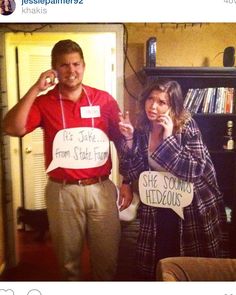 a man and woman standing next to each other with signs in front of their mouths