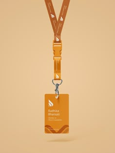 an orange lanyard with a name tag hanging from it's side, on a beige background