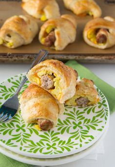 sausage and egg breakfast rolls on a plate with a fork