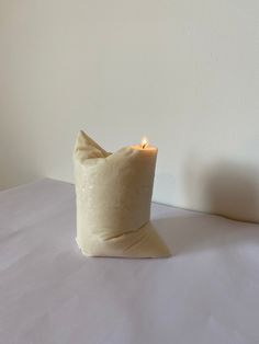 a candle that is sitting on top of a bed