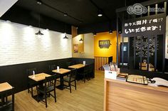 an empty restaurant with wooden tables and chairs