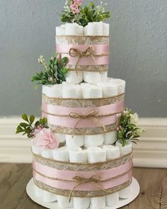 a three tiered cake made out of marshmallows and burlocks