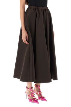 VALENTINO midi skirt crafted in heavyweight technical duchesse, characterized by a flared fit featuring elastic drawstring waistband and silk-lined side inseam pockets. The model is 177 cm tall and wears a size IT 40. Size Info IT Color Detail Brown Made In Italy Material 82%PL 18%SE Season One spring Season Two summer Product clothing Brand Valentino Size And Fit Workwear Midi-length Draped Skirt, Workwear Midi Dress With Gathered Skirt, Evening Midi Skirt With Pleated Waist, Midi-length Draped Skirt For Workwear, Evening Skirt With Pleated Waist Midi Length, Chic Midi Bottoms With Gathered Waist, Long Skirt Dress With Gathered Detail For Workwear, Gathered Midi Skirt For Evening, Gathered Long Skirt Dress For Work