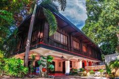 a house that is surrounded by trees and plants