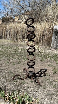 a metal sculpture in the middle of a field