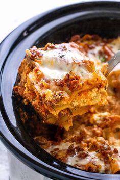 a close up of a casserole in a crock pot with a spoon