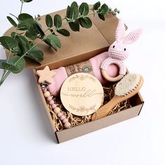 a box filled with toys and greenery next to a potted plant