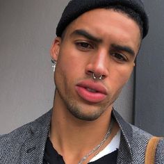 a young man with piercings on his nose