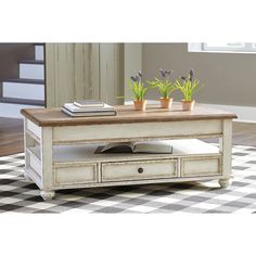 a coffee table with drawers and plants on top