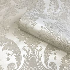 a white and silver wallpaper with an intricate design on it's surface,