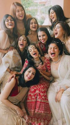 a group of women posing for the camera with their mouths wide open and laughing together