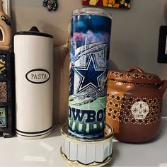 three different items are sitting on a counter top, one has a canister and the other is a ceramic jar