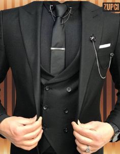 A three-piece suit typically consists of a jacket, trousers, and a waistcoat (vest). Here's a breakdown of each component: Jacket: The suit jacket is tailored to fit the body, often featuring a notched or peaked lapel, and can come with a single or double-breasted front. It usually has two or three buttons and may include pockets with flaps, a ticket pocket, and sometimes a subtle pattern or texture. Trousers: The trousers are designed to complement the jacket, often featuring a flat front or pl Groom Tuxedo Wedding, Tie Chain, Tuxedo Wedding Suit, Black Suit Men, Slim Fit Suit Men, Suits Men Business, Groom Tuxedo, Summer 19, Dress Suits For Men