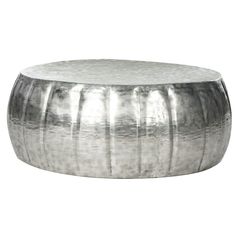 a round metal table with silver paint on the top and bottom, sitting in front of a white background