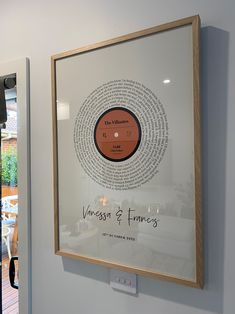 a framed record on the wall in a room