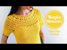 a woman wearing a yellow crochet top with her hands in her pockets and looking off to the side