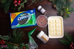 the ingredients to make an ice cream dessert are displayed on a table with pine branches