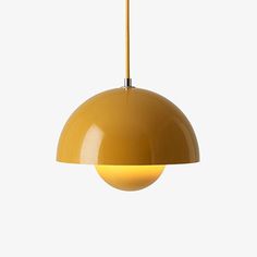 a yellow pendant light hanging from a ceiling